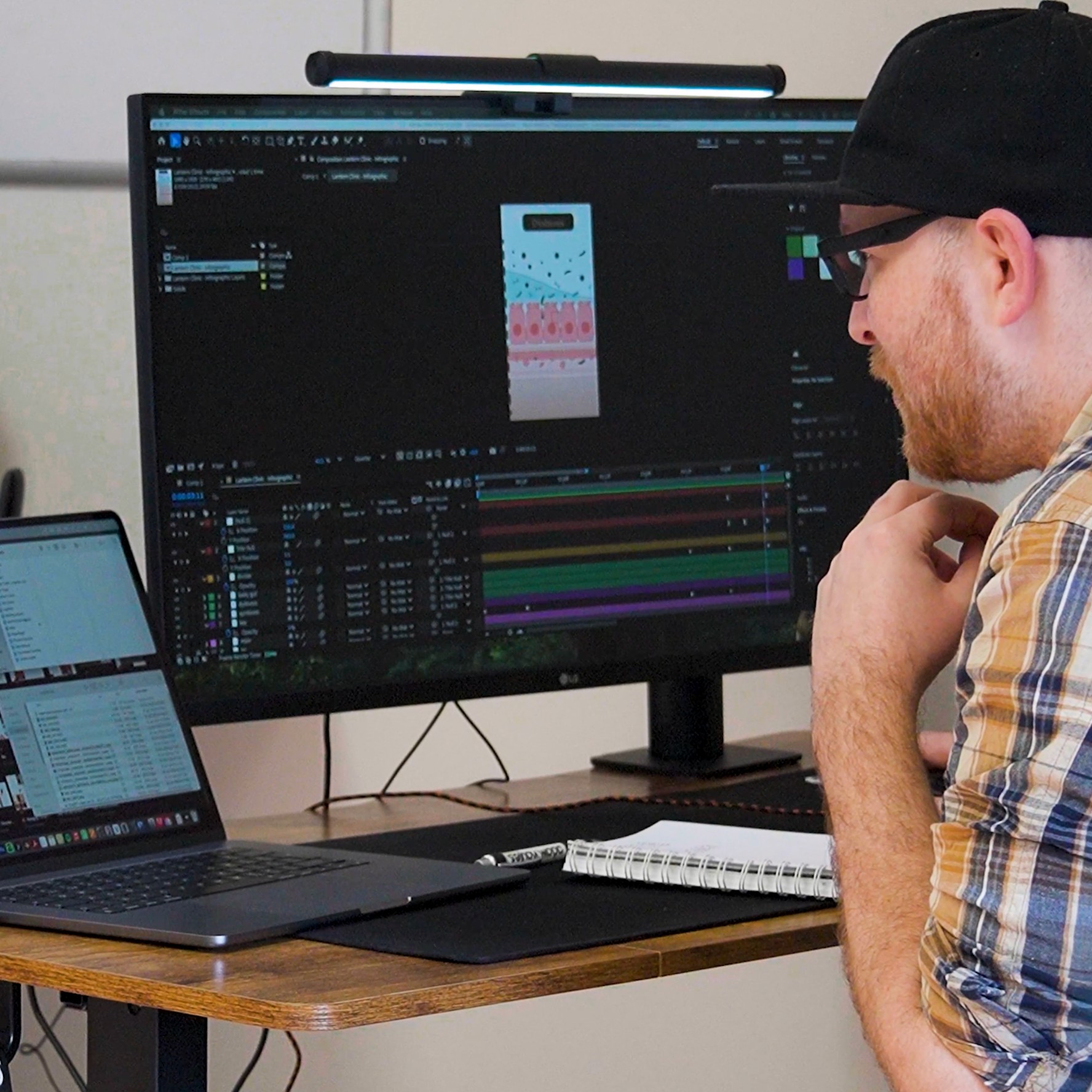 Graphic designer, Adam Hayles, working on a client project within an agency environment as a freelance designer